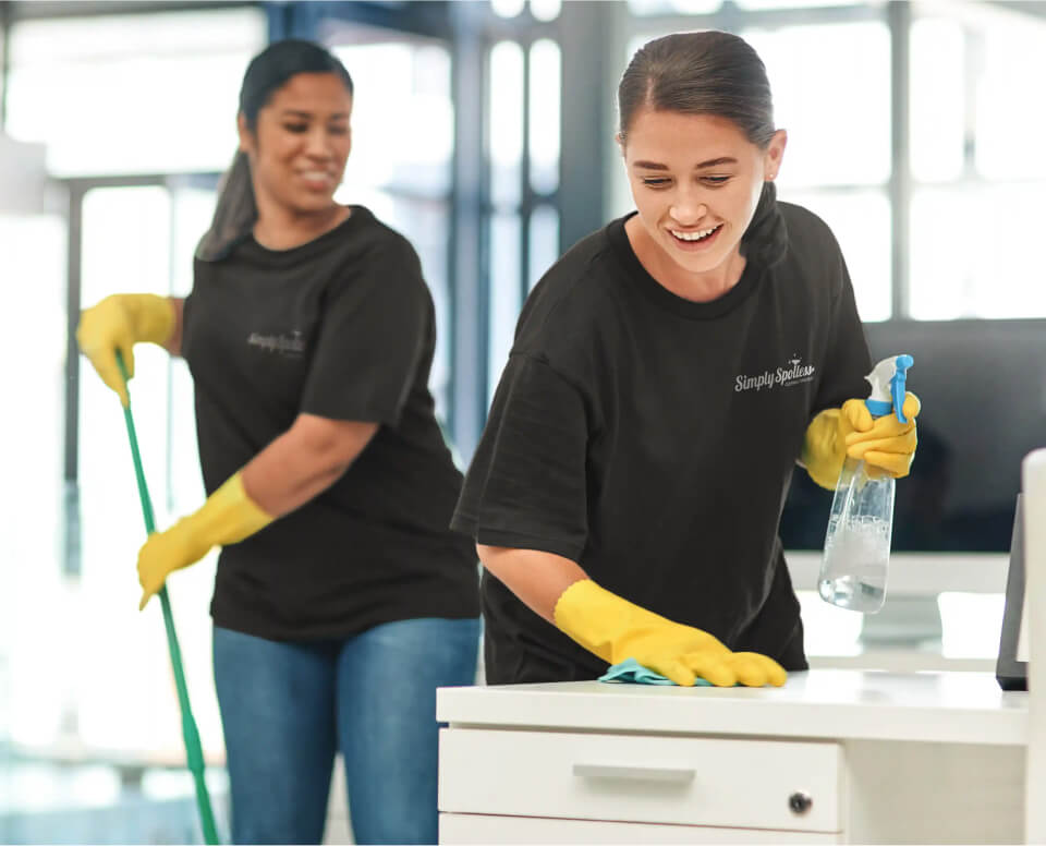 Simply Spotless cleaner, cleaning a modern bathroom inside a customer home