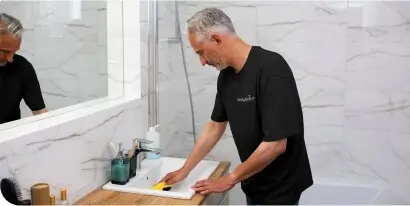 Simply Spotless House Cleaning Services Simply Spotless cleaner cleaning a bathroom sink during a domestic cleaning service
